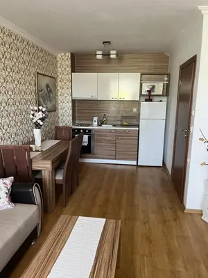a kitchen and living room with a table and a refrigerator at Apart Sweet Homes 5 - Apartments for guests in Sunny Beach