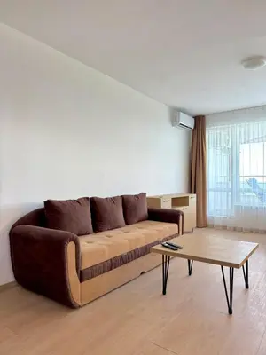 a living room with a couch and a coffee table at Byala sea view apartment Studio in Byala