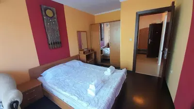 a small bedroom with a bed and a mirror at 2 Room Apartment Gallery with Poolview in Sunny Beach