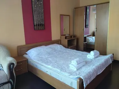 a bedroom with a bed with two towels on it at 2 Room Apartment Gallery with Poolview in Sunny Beach