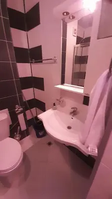 a bathroom with a sink and a toilet and a mirror at 2 Room Apartment Gallery with Poolview in Sunny Beach
