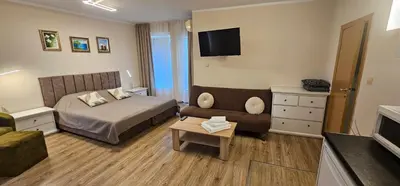 a hotel room with a bed and a couch at Blue Bay House in Nesebar
