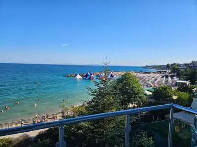 a view of a beach with people in the water at Blue Bay House in Nesebar