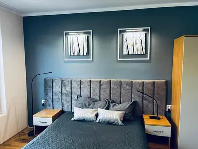 a bedroom with a bed with two pictures on the wall at Blue Bay House in Nesebar