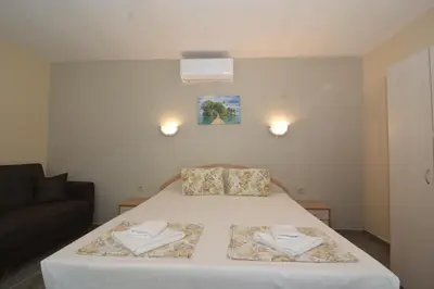 a bedroom with a bed with two towels on it at Atlantic Complex Ravda in Ravda