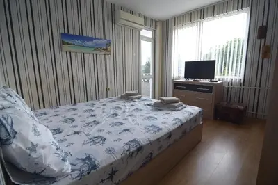 a bedroom with a bed and a television in it at Atlantic Complex Ravda in Ravda
