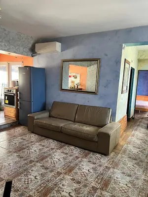 a living room with a couch and a refrigerator at Burgas Biju in Burgas City