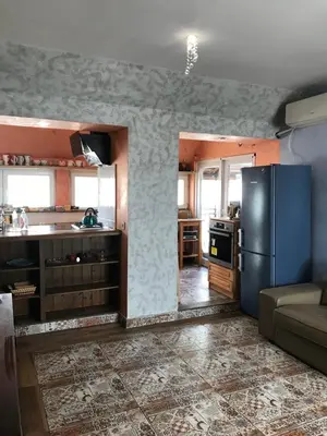 a kitchen with a blue refrigerator in a room at Burgas Biju in Burgas City