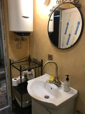 a bathroom with a sink and a mirror at Burgas Biju in Burgas City
