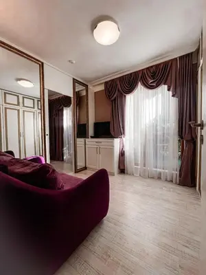 a living room with a couch and a large window at Monte Carlo Vaio - 1BR Garden Apt - With Direct Pool Access in Sunny Beach