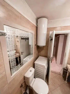 a bathroom with a toilet and a sink and a mirror at Monte Carlo Vaio - 1BR Garden Apt - With Direct Pool Access in Sunny Beach