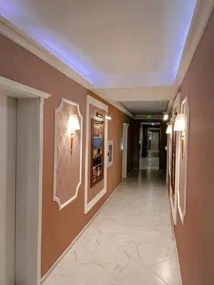 a hallway in a building with brown walls at Monte Carlo Vaio - 1BR Garden Apt - With Direct Pool Access in Sunny Beach