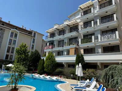 a hotel with a swimming pool in front of a building at VP Villa Valencia in Sunny Beach