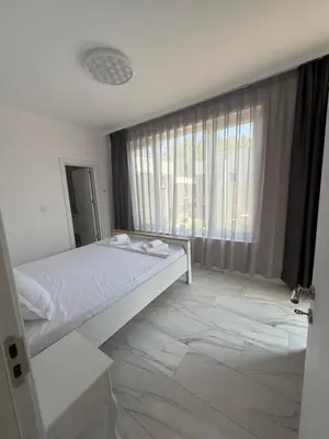 a bedroom with a bed and a large window at Aurum Villas Smokinya Beach 4 in Sozopol