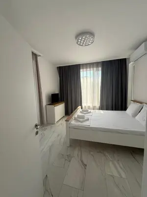 a bedroom with a bed and a large window at Aurum Villas Smokinya Beach 4 in Sozopol