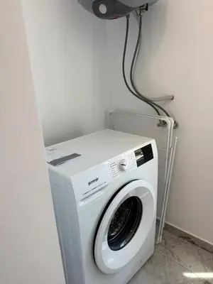 a washer and dryer in a corner of a room at Aurum Villas Smokinya Beach 4 in Sozopol