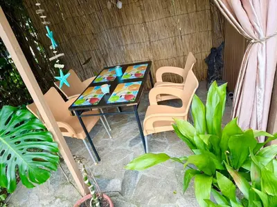 a table and chairs in a room with plants at Apartment in Desi's house in Obzor
