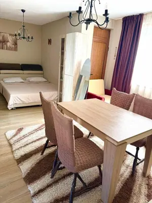 a dining room with a table and chairs and a bedroom at Apartment in Desi's house in Obzor