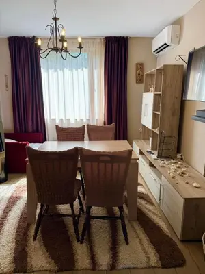 a living room with a dining room table and chairs at Apartment in Desi's house in Obzor