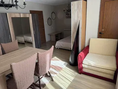 a room with a table and chairs and a bedroom at Apartment in Desi's house in Obzor