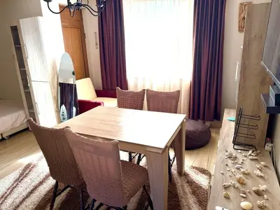 a dining room with a table and chairs in a room at Apartment in Desi's house in Obzor