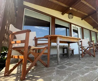a patio with a table and chairs on a porch at Къща за гости тип Бунгало Арапя, Царево in Tsarevo