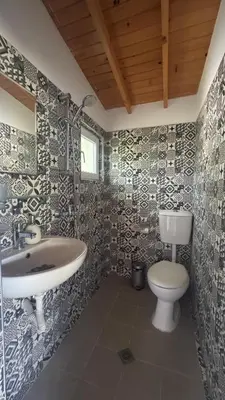 a bathroom with a sink and a toilet at Къща за гости тип Бунгало Арапя, Царево in Tsarevo