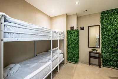 a room with two bunk beds and a mirror at Heart of the city Hostel in Varna City