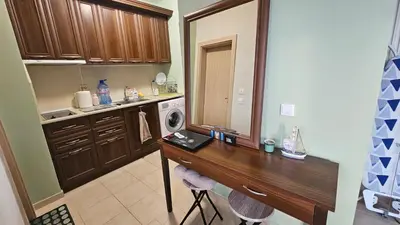 a kitchen with a wooden counter and a washing machine at Studio Vanita in Sozopol