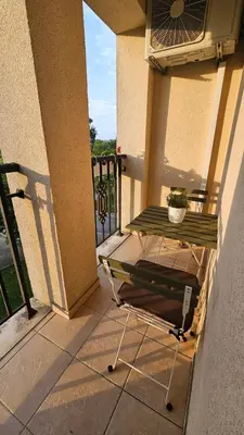 a table on a balcony with a plant on it at Studio Vanita in Sozopol