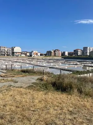 a body of water with buildings in the background at Atlantic in Pomorie