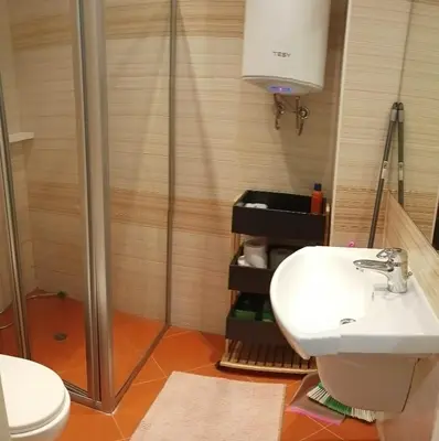 a bathroom with a shower and a toilet and a sink at Atlantic in Pomorie
