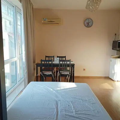 a bedroom with a bed and a table and chairs at Atlantic in Pomorie