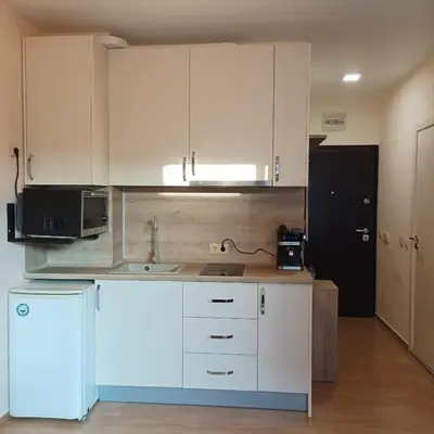 a kitchen with white cabinets and a microwave at Atlantic in Pomorie