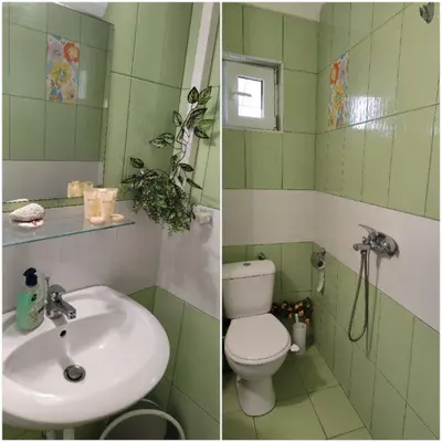 a green bathroom with a toilet and a sink at Studio Juli in Lozenets