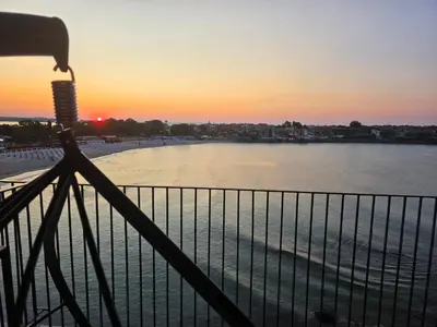 a view of the ocean from a balcony at sunset at Магията на Созо in Sozopol