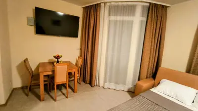 a room with a table and a room with a bed at Luxurious Apartment with sea view in Pomorie