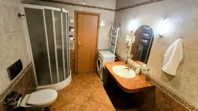 a bathroom with a toilet and a sink and a shower at Luxurious Apartment with sea view in Pomorie