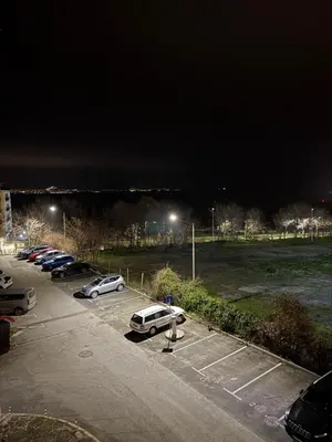 a parking lot with cars parked in it at night at Windmill Nessebar studio with sea view in Nesebar