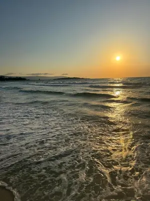 a sunset on the beach with the ocean at Windmill Nessebar studio with sea view in Nesebar