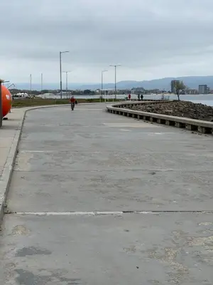 a parking lot with a person riding a bike at Windmill Nessebar studio with sea view in Nesebar