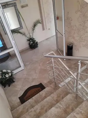 a staircase with a metal railing in a building at Семеен хотел Вермона in Primorsko