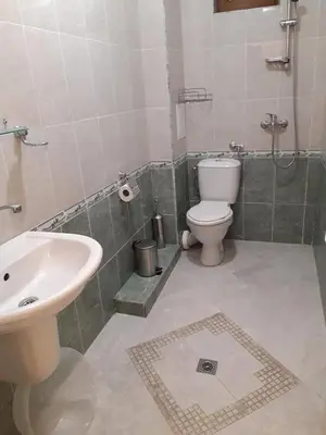 a bathroom with a toilet and a sink at Семеен хотел Вермона in Primorsko