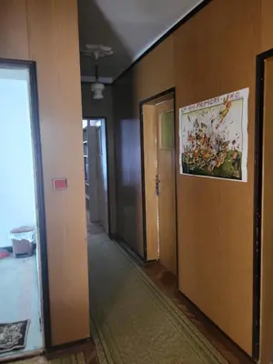 a hallway with a door and a poster on the wall at Апартамент Стоянови in Primorsko