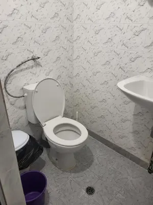 a bathroom with a toilet and a sink at Апартамент Стоянови in Primorsko