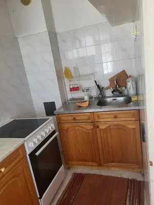 a kitchen with a sink and a stove at Апартамент Стоянови in Primorsko