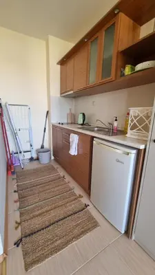 a kitchen with two rugs on the floor next to a refrigerator at Studio in Relax Complex, Sveti Vlas in Sunny Beach