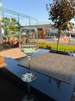 a glass of wine sitting on top of a table at Black Sea Residence Aheloy in Aheloy