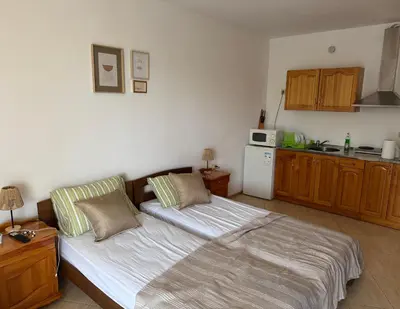 a living room with a bed and a kitchen at Black Sea Residence Aheloy in Aheloy