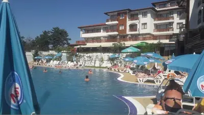 a resort swimming pool with people in the water at Gardenia Hills in Sunny Beach